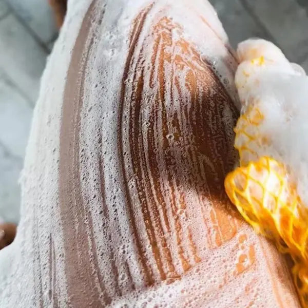 Soap lather from a net on skin